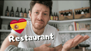 Miniature de vidéo avec une photo de Pierre dans une cuisine et le titre « restaurant » avec un drapeau espagnol, illustrant un article Holamigo