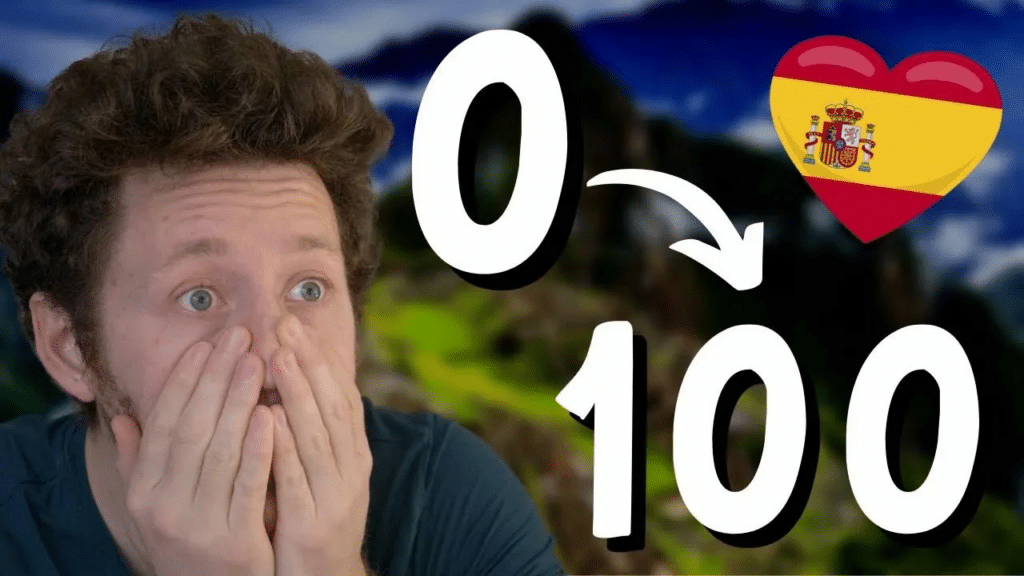 Miniature de vidéo avec une photo de Pierre dans une cuisine et les nombres 0 et 100 avec une flèche entre les deux et un drapeau espagnol, illustrant un article Holamigo